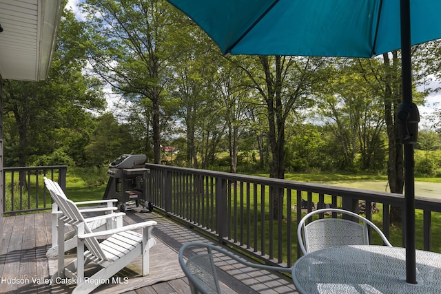 wooden terrace with a grill