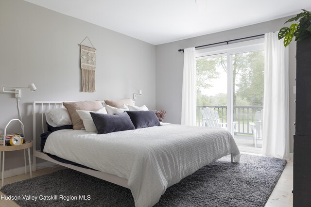 bedroom with light hardwood / wood-style floors and access to exterior