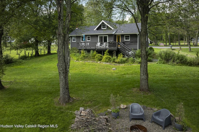 view of front of home featuring a front lawn and a deck