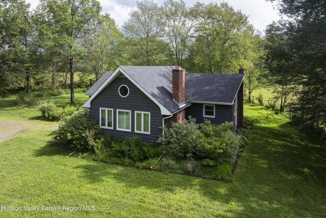 view of side of property featuring a yard