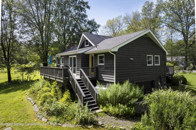 exterior space featuring a lawn and a deck