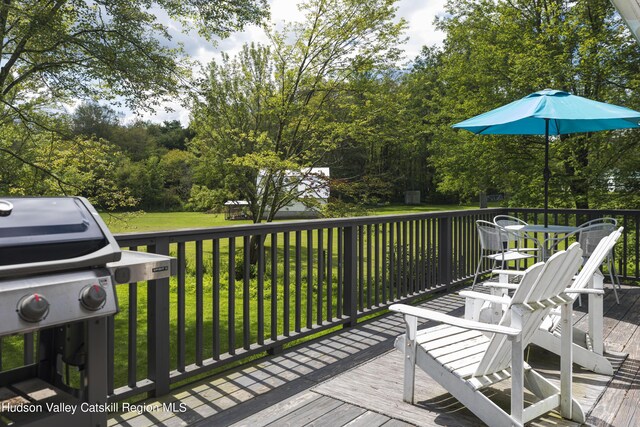 wooden deck with a lawn