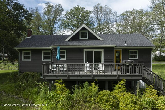 rear view of property featuring a deck