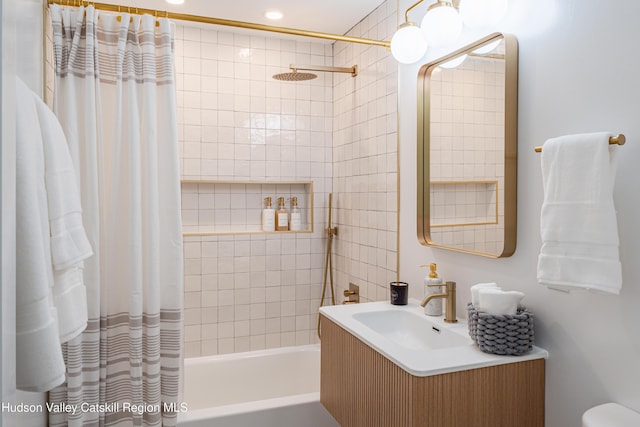 bathroom featuring shower / bath combo and vanity