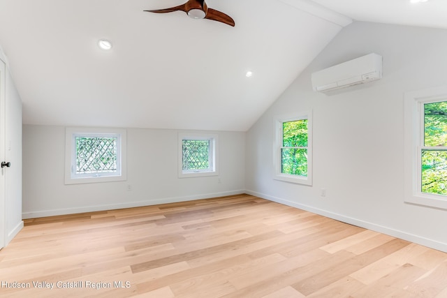 bonus room with ceiling fan, light wood-type flooring, an AC wall unit, and vaulted ceiling