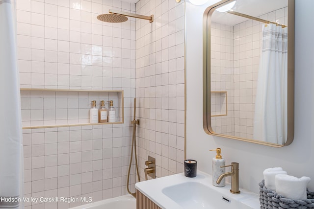 bathroom featuring shower / bathtub combination with curtain and sink