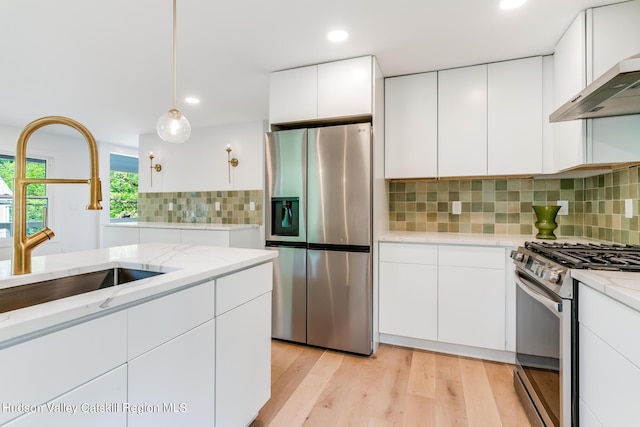 kitchen featuring white cabinetry, sink, and appliances with stainless steel finishes