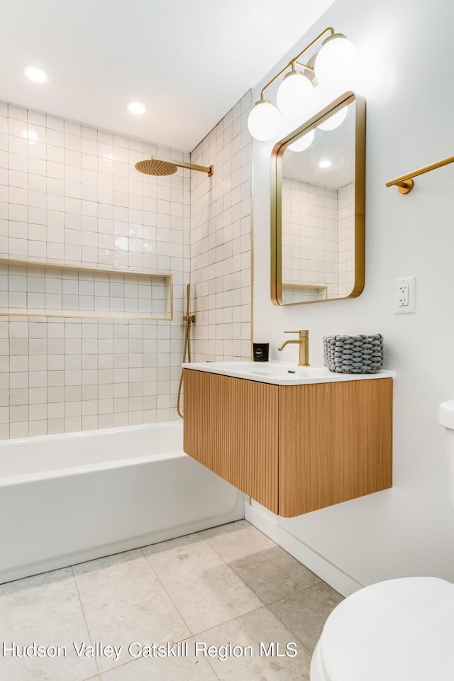 full bathroom with vanity, toilet, and tiled shower / bath