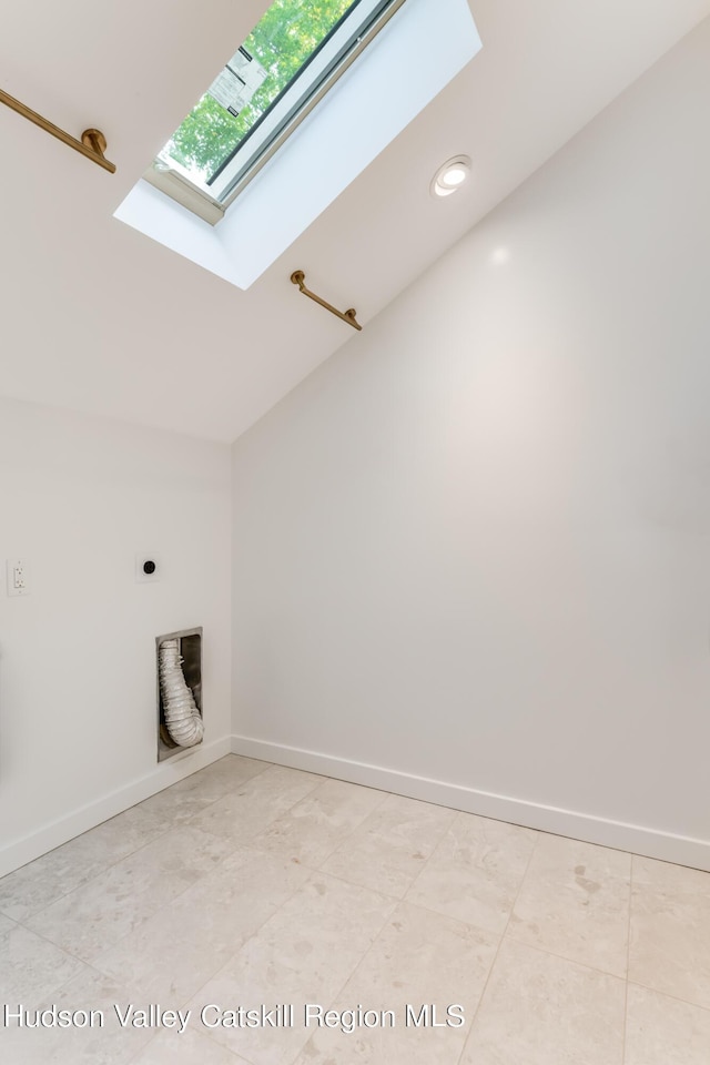 clothes washing area with hookup for an electric dryer and a skylight