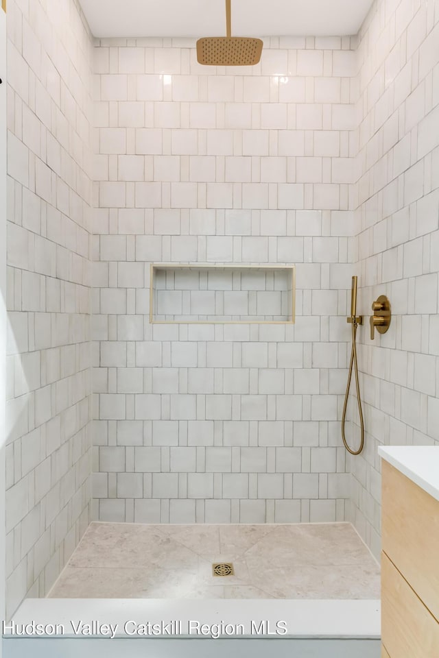 bathroom with a tile shower