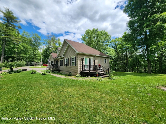 back of house featuring a yard and a deck