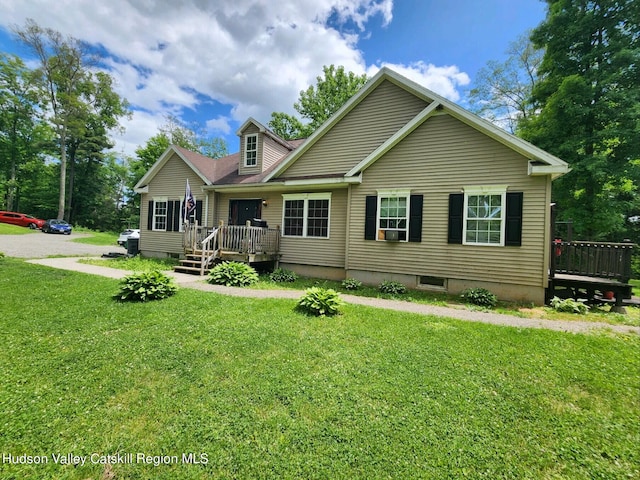 view of front of home with a front yard and a deck