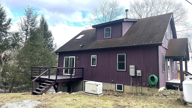 rear view of property featuring a deck