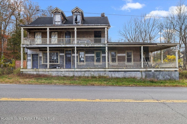 view of front of home with a balcony and covered porch