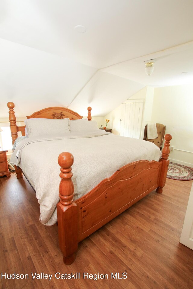 604 Columbia St, Hudson, NY 12534 - bedroom featuring wood finished floors and vaulted ceiling