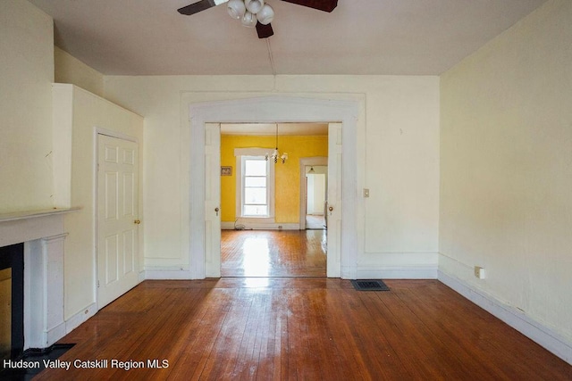 604 Columbia St, Hudson, NY 12534 - empty room featuring ceiling fan, hardwood / wood-style flooring, baseboards, and a chandelier