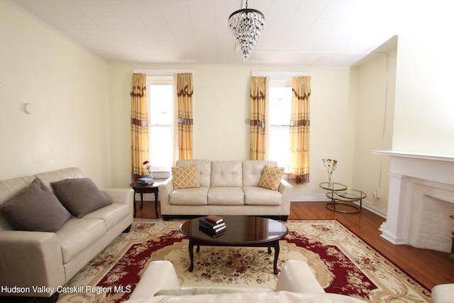 604 Columbia St, Hudson, NY 12534 - living room featuring plenty of natural light, wood finished floors, a fireplace, baseboards, and crown molding