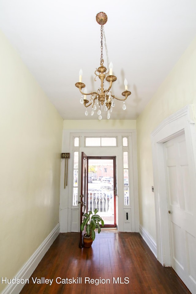 604 Columbia St, Hudson, NY 12534 - entrance foyer with a chandelier, baseboards, and hardwood / wood-style flooring
