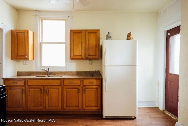 604 Columbia St, Hudson, NY 12534 - kitchen featuring freestanding refrigerator, a sink, and brown cabinets