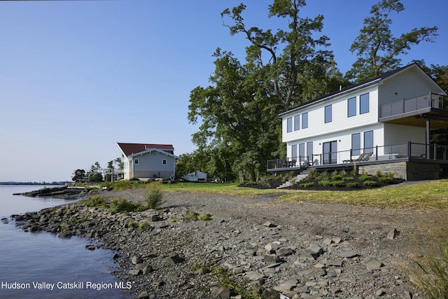 rear view of property featuring a water view