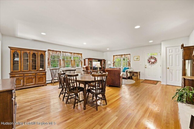 dining area featuring light hardwood / wood-style floors and a baseboard heating unit