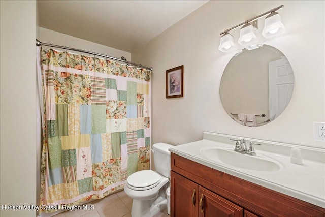 bathroom with tile patterned flooring, vanity, and toilet