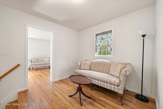 sitting room with light wood-type flooring and baseboards