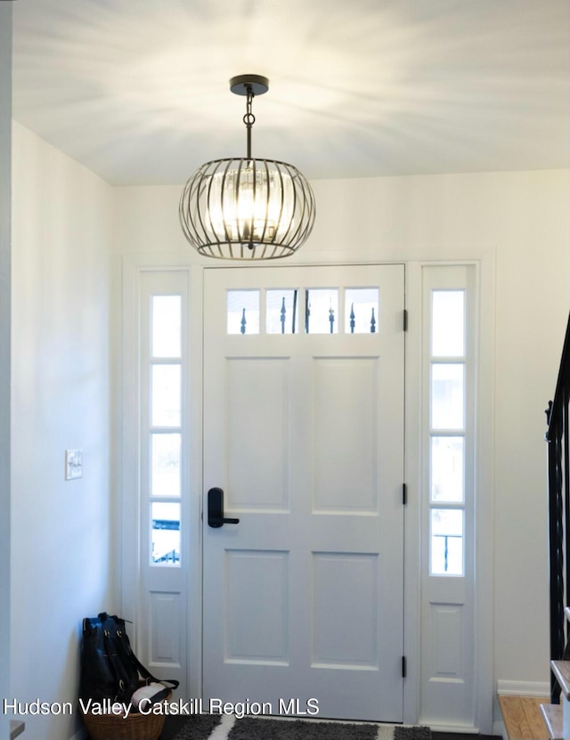 foyer entrance with an inviting chandelier