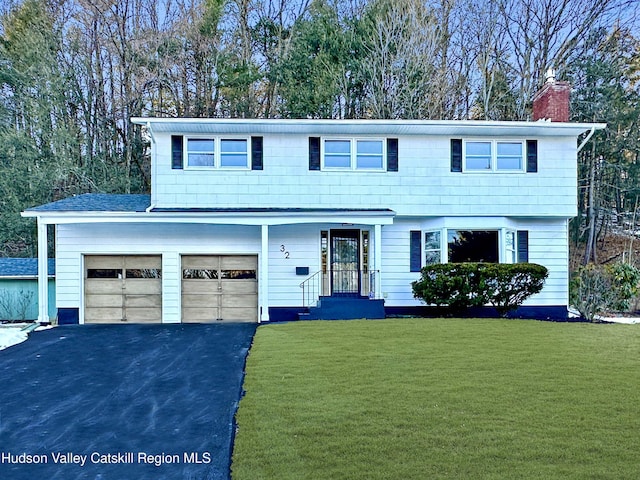 32 Redwood Rd, Saugerties, NY 12477 - colonial inspired home featuring a front yard, driveway, and a chimney