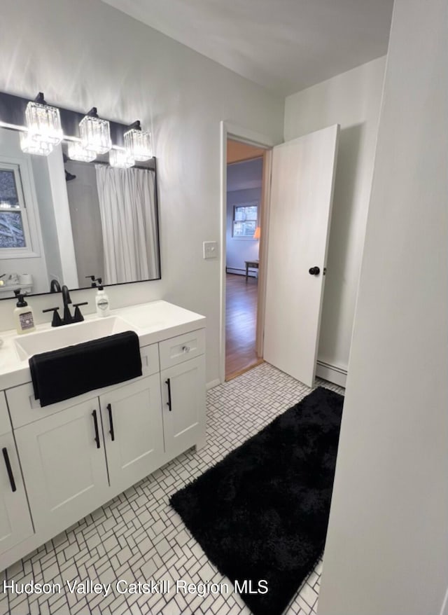 bathroom featuring vanity, tile patterned floors, and baseboard heating