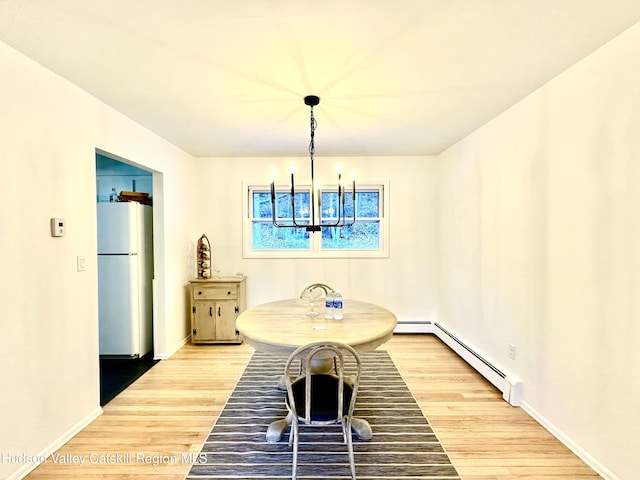 32 Redwood Rd, Saugerties, NY 12477 - dining space with a notable chandelier, a baseboard radiator, baseboards, and wood finished floors