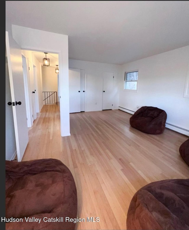 interior space with light hardwood / wood-style floors and baseboard heating