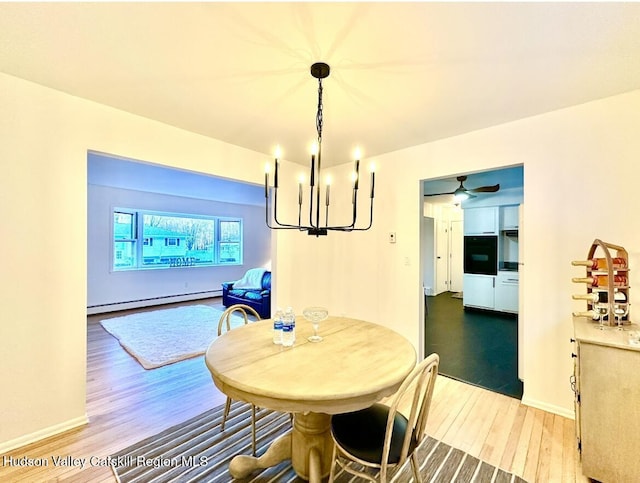 32 Redwood Rd, Saugerties, NY 12477 - dining room featuring a notable chandelier, a baseboard heating unit, wood finished floors, and baseboards