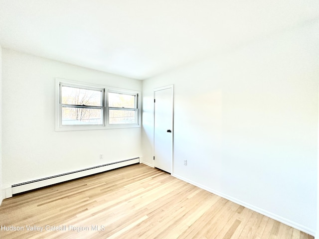 32 Redwood Rd, Saugerties, NY 12477 - spare room with baseboards, a baseboard heating unit, and wood finished floors
