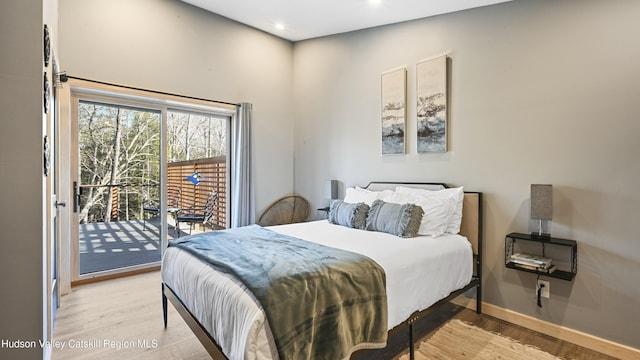 bedroom with access to exterior and light hardwood / wood-style flooring