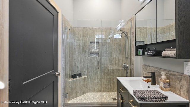 bathroom featuring vanity and an enclosed shower