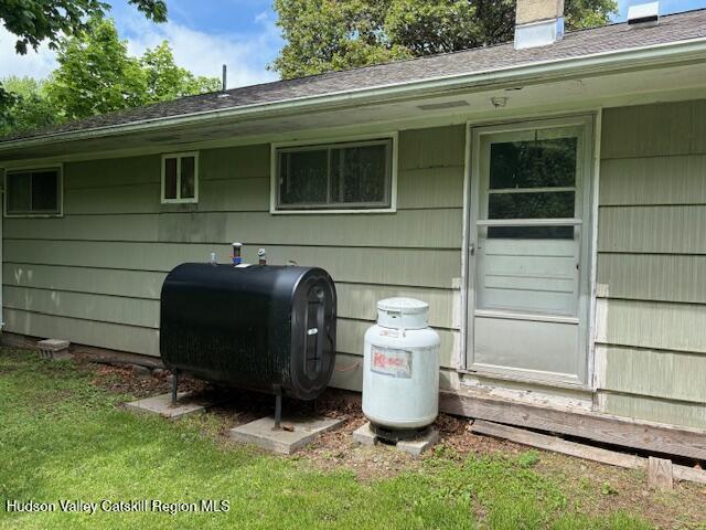 36 Blue Mountain Mnr, Saugerties, NY 12477 - exterior view of heating fuel, heating fuel tank, and a chimney