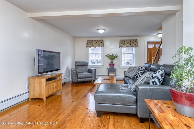 living room featuring light wood finished floors, stairway, and a baseboard radiator