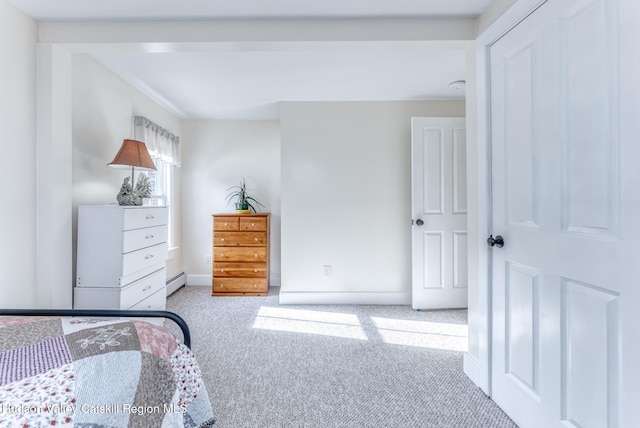 carpeted bedroom with a baseboard radiator and baseboards