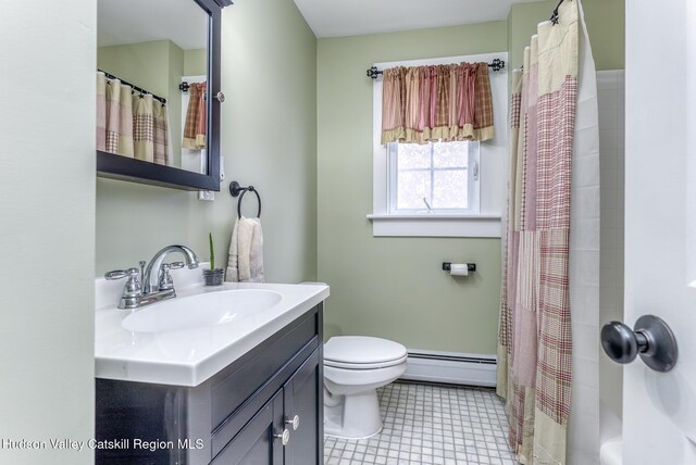 bathroom with toilet, curtained shower, a baseboard heating unit, and vanity