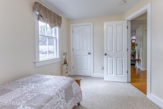 bedroom with carpet flooring and baseboards