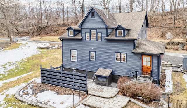 back of property featuring fence, a patio, and roof with shingles