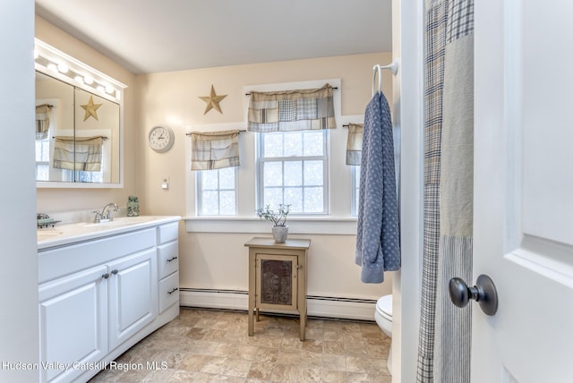 bathroom with toilet, a baseboard radiator, and vanity