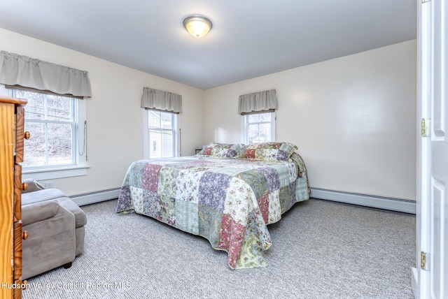 bedroom with carpet floors and a baseboard heating unit