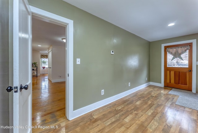 foyer featuring light wood-type flooring, baseboards, and recessed lighting