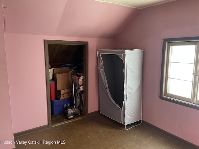 unfurnished bedroom with vaulted ceiling