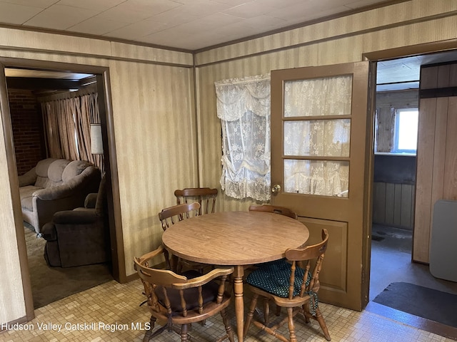 dining area featuring light tile patterned flooring and radiator heating unit