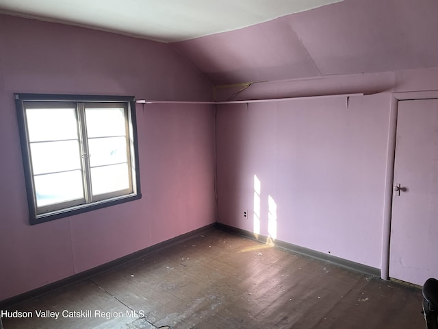 empty room with vaulted ceiling