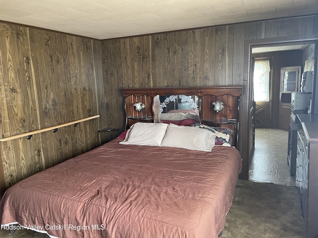 carpeted bedroom featuring wooden walls