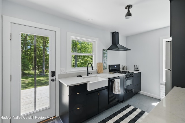 766 County Route 2, Accord, NY 12404 - kitchen featuring gas stove, wall chimney exhaust hood, a sink, dark cabinetry, and light tile patterned flooring